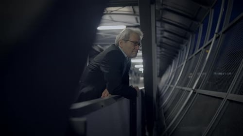 A Businessman on a Balcony at Night Reflecting on His Work and Contemplating the City