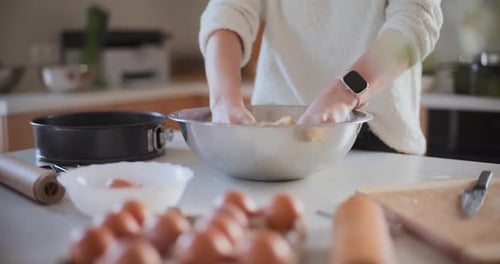 Hands Mixing Food Ingredients in Bowl
