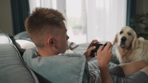Young Adult Gaming at Home with Dog