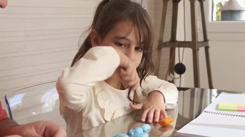 Child and Adult Crafting Together at Table