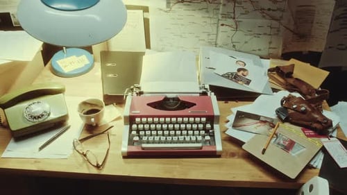 Close-Up of Vintage Typewriter and Criminal Investigation Materials on Desk