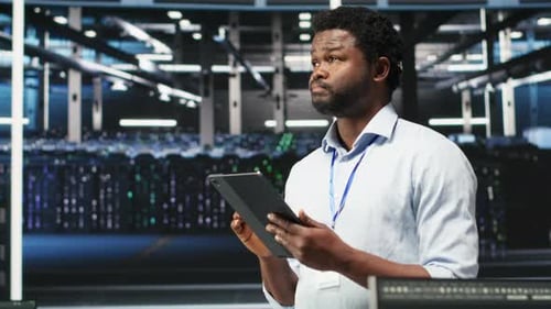 Data Center Engineer Using Tablet to Interpret AI Generated Data Analytics Graphs