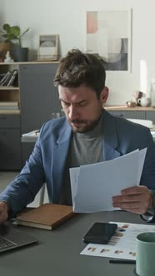 Office Worker Reviewing Documents and Using Laptop, then Taking Break