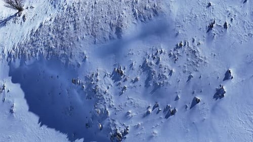 Drone Aerial Tilt Reveal Over Snowy Mountains Rising to Ski Resort View in Abruzzo Italy