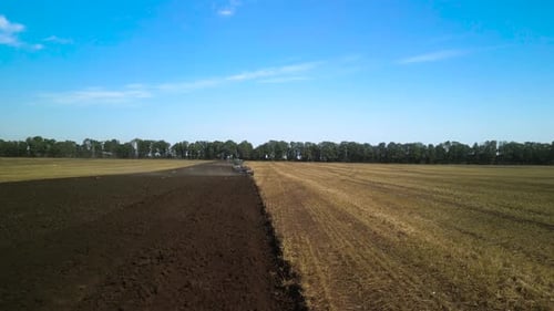 Tractors plowing the field in Ukraine