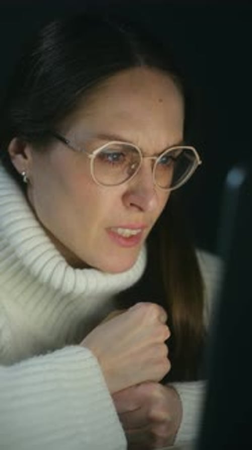 Stressed Woman Working on a Computer at Night
