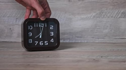 Male Hand Puts an Arrow Mechanical Watch on a Wooden Table