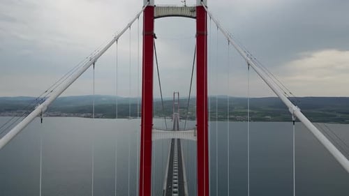 Suspension Bridge Captured From Midspan with Retreating Aerial View