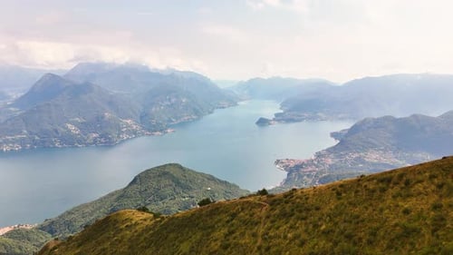 Mountain Lake View Over Expansive Valley and Distant Peaks Under Soft Daylight Atmosphere