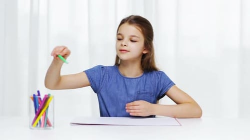 Girl Drawing with Green Marker on Paper