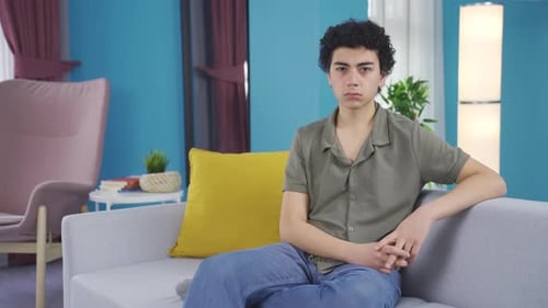 Young Adult Sitting on Couch at Home