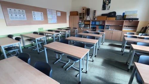 Empty Classroom with Tables and Chairs