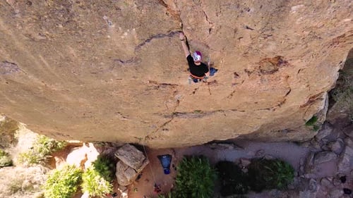 Man rock climbing aerial view of sportsman rapelling mountain in La Panocha, el Valle Murcia, Spain