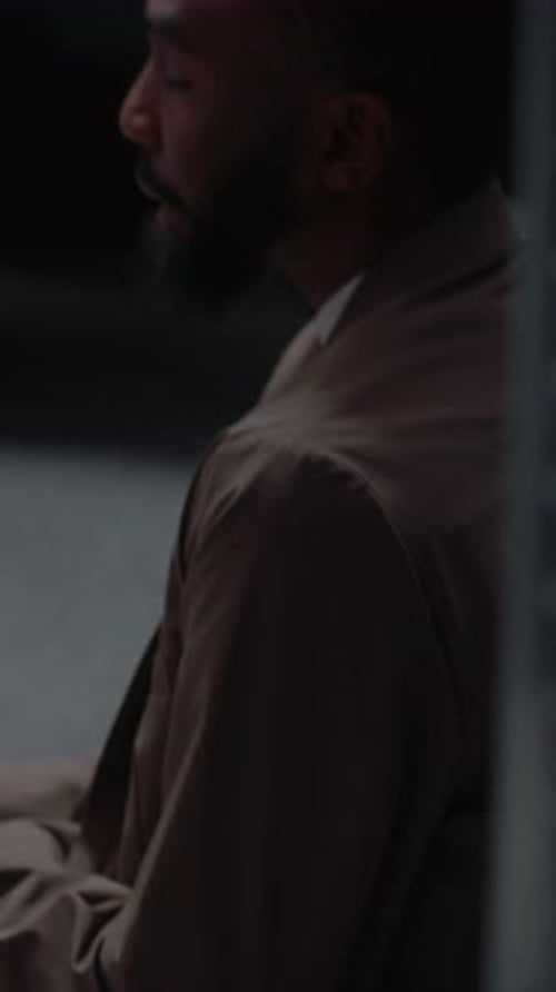 Man Sits Thoughtfully in a Workplace Setting