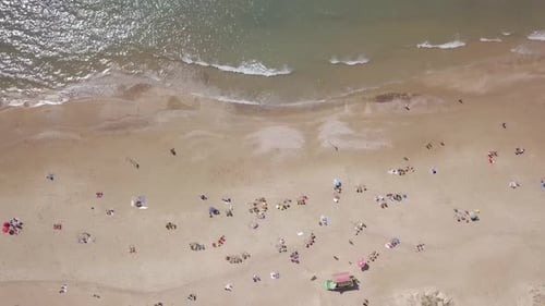 Mediterranean beach during summer with people in the water
