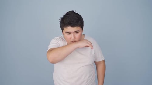 Sick boy coughing.