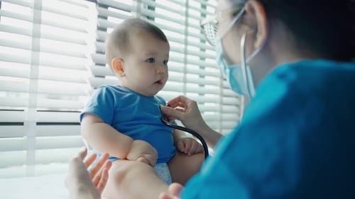 Doctor Listens to Infant's Heart with Stethoscope