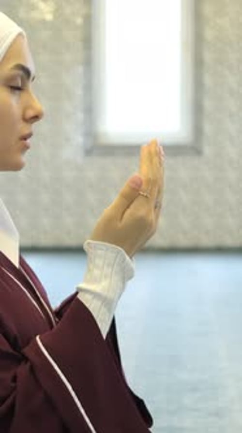 Young Woman Raising Hands in Prayerful Supplication