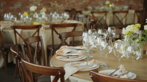 a Wedding Banquet Hall with Set Tables with Vintage Chairs
