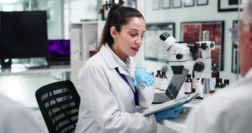 Scientists Discussing Research Findings in Bright Laboratory