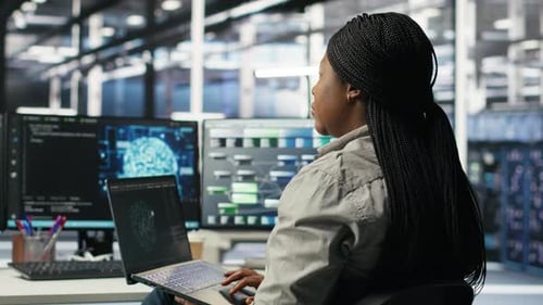 Woman Working on Laptop in Futuristic Office