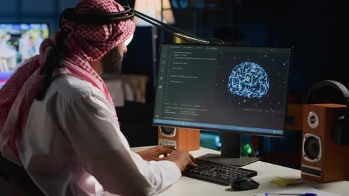 Person Coding Artificial Intelligence in a Dim Office