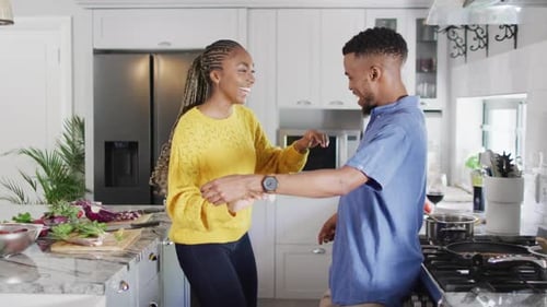Young Couple Dancing in Modern Kitchen at Home