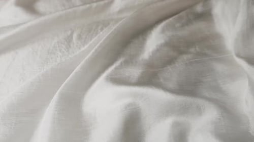 Natural silk fabric waving in the wind. Abstract background of white soft waves.