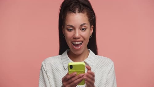 Excited Woman Reacts to Smartphone News