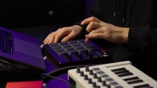 Hands Using Beat Machine to Create Music