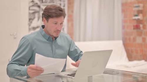 Excited Man Celebrating Good News While Working At Home