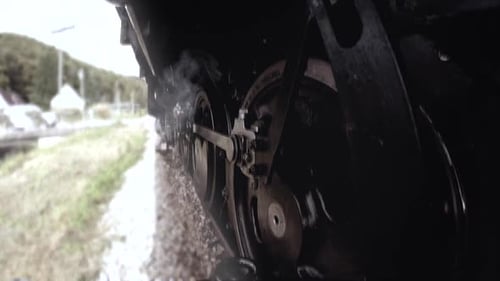 Historical Steam Engine Train Locomotive Driving on Railroad Tracks