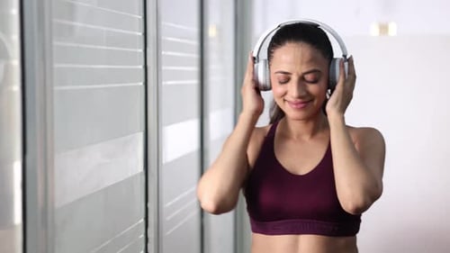 Woman Dancing and Listening to Music on Headphones
