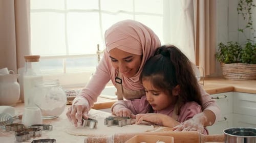 Mother and Daughter Baking Together in a Cozy Kitchen Filled with Love