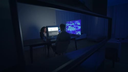 Business Colleagues Reviewing Charts at Night