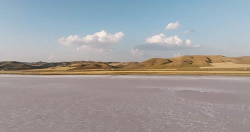 Aerial view of vibrant salt flats with rugged mountains in Turkey