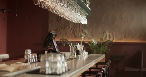 Wineglass Rack Above Counter with Computer in Bar