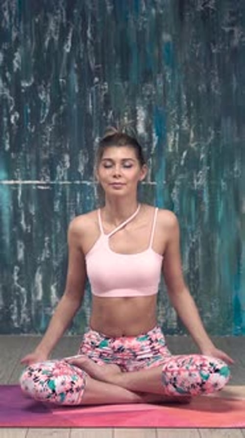 Woman Meditating in Lotus Pose on Yoga Mat