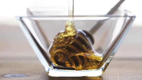 Healthy Food, Eating, Natural Cosmetics and Objects Concept - Honey in Glass