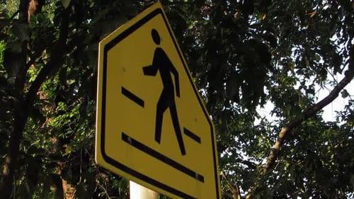 Pedestrian Crossing Road Sign with Green Trees