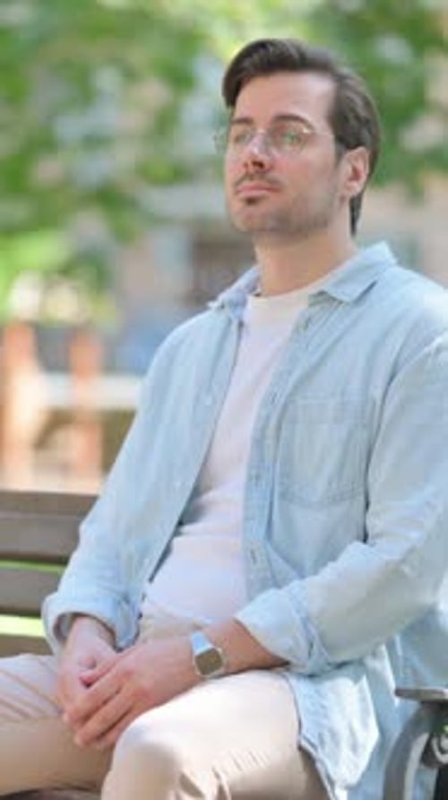 Casual Middle Aged Man Sitting in Park