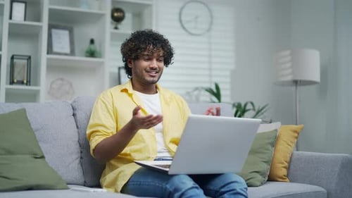 Young Man on Laptop Video Call at Home