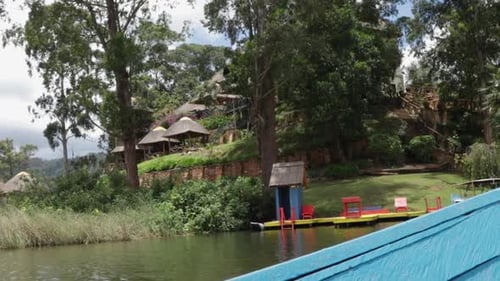 View Of A Luxury Resort And Dock From A Boat In Uganda, Africa.