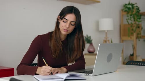 Young Professional Business Woman Working on Laptop at Home Office