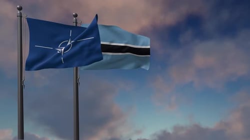 NATO and Botswana Flags Waving on Flagpoles