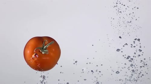 Tomato Falls Into Water