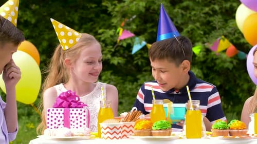 Children Celebrate at Outdoor Birthday Party With Gifts