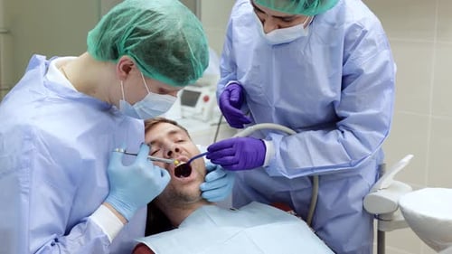 Dentist Applies an Injection of Anesthetic with a Syringe in a Dental Clinic Dental Treatment
