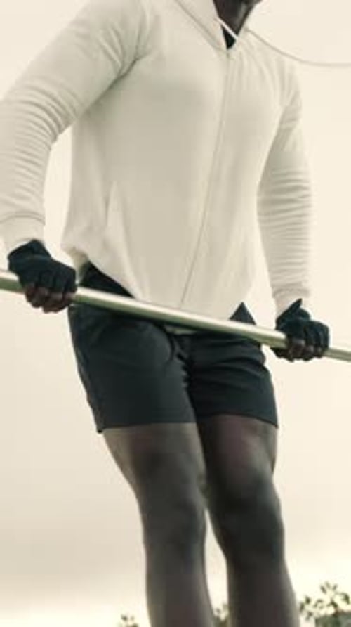 Man doing pull-ups on a horizontal bar, street workout