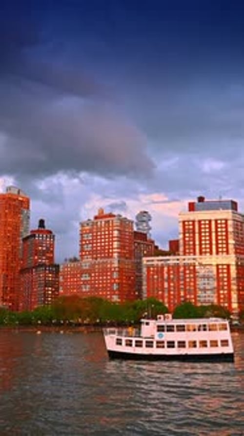 Riverboat on the riverscape on a gloomy day. New York skyline under the dramatic cloudscape